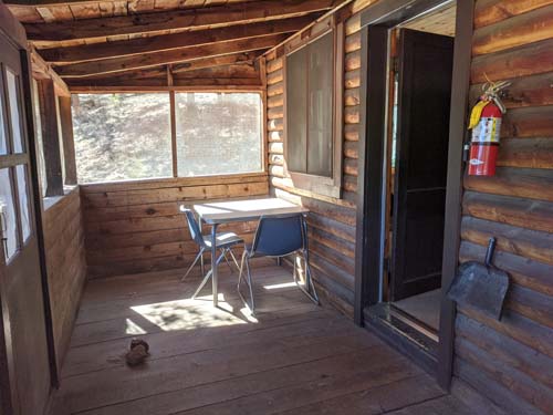 The screened in porch in the Grand Fir Cabin at Long Scraggy Mountain Ranch
