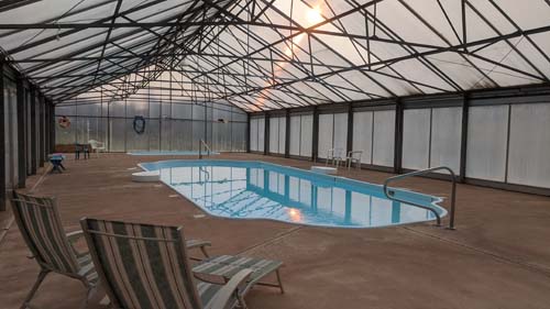 Indoor swimming pool facility with two lounge chairs