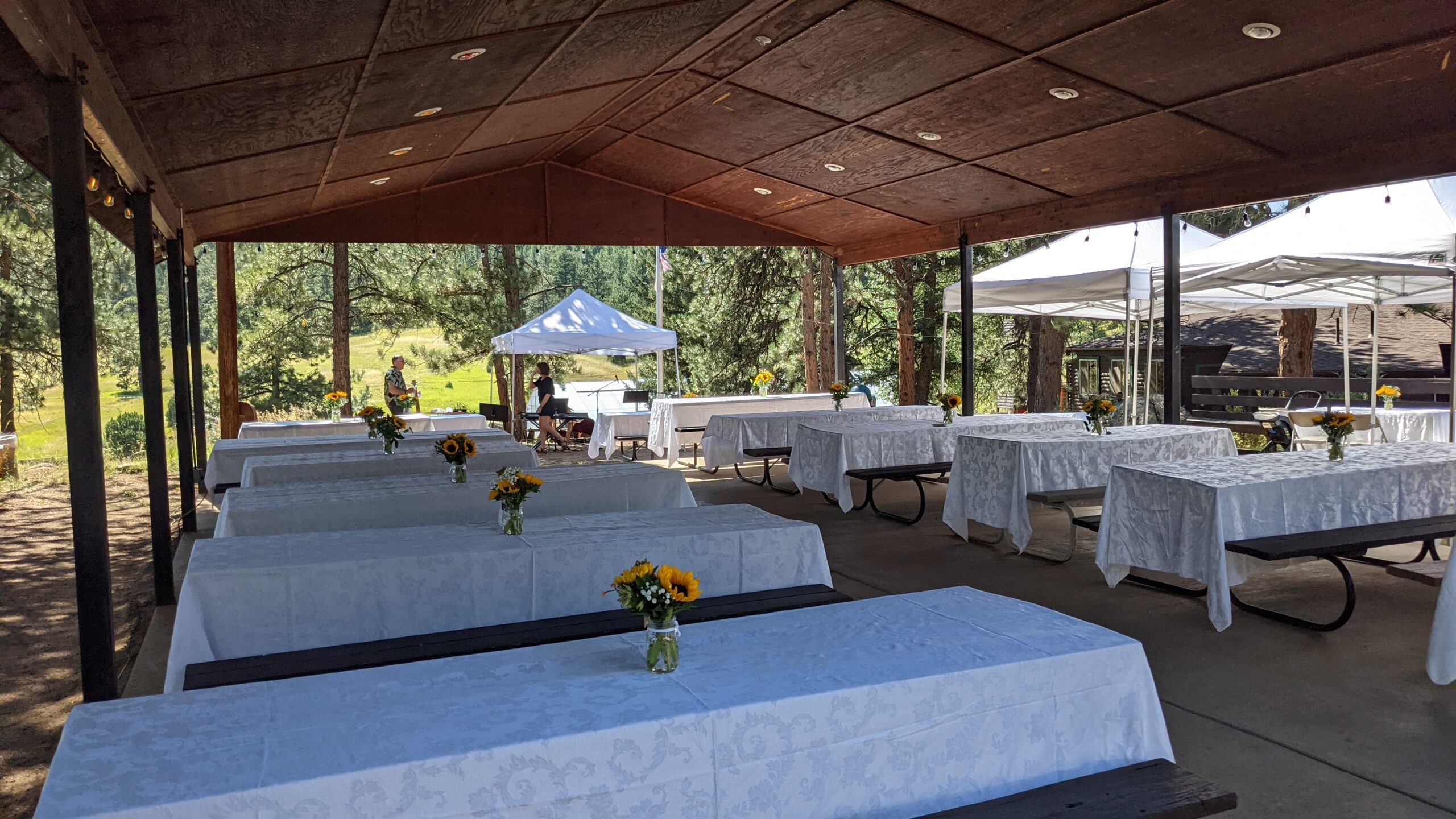 The picnic pavilion, seen here dressed in white linen tablecloths, is an open-air feature of the Long Scraggy retreat facility